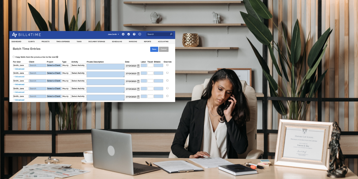 Female lawyer sitting at her desk, on the phone while looking at Bill4Time software on her computer